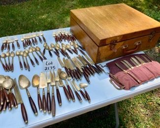Lot 2175. $195.00. Vintage Brass with Rosewood Handled Flatware. 12 place settings; each setting has 11 pieces which include a steak knife, there are 12 additional serving pieces for a total of 144pcs. There is a storage box that is in rough shape but contains a storage area & covered drawer. Possible old Thailand/Siam flatware, not marked.