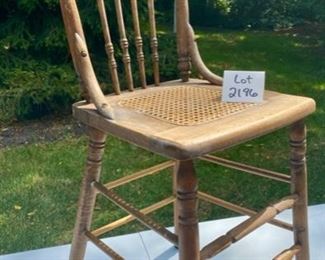 Lot 2196 $25.00 Vintage Cane Chair with Spindle Back and Carved Wood on Back of Seat Great condition! The scale of this chair is narrow and a little small, but high, sorry we don't have measurements for you!