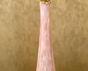 Lot 2140. Firm: $1,100.00. Handblown Murano MCM/Hollywood Regency Lamp. Ribbed Glass. Glass is pink with an underlay of cranberry and gold. Lamp tested. We didn't have a shade that paired well with this lamp. It is STUNNING. The homeowner got this lamp from her Aunt, who had it in the 50's. 35 1/2" to top of Finial x 7.5" brass base. There are two slight imperfections in the ribbing, barely noticeable. One feels as though it was part of the making process and the other one may have been a small ding that looks like it was professionally smoothed. Online a pair of these lamps have fetched $6,800 and similar versions of singleton lamps have sold for $3,500. Truly magnificent!