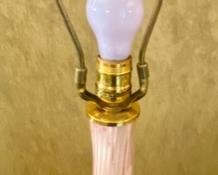 Lot 2140. Firm: $1,100.00. Handblown Murano MCM/Hollywood Regency Lamp. Ribbed Glass. Glass is pink with an underlay of cranberry and gold. Lamp tested. We didn't have a shade that paired well with this lamp. It is STUNNING. The homeowner got this lamp from her Aunt, who had it in the 50's. 35 1/2" to top of Finial x 7.5" brass base. There are two slight imperfections in the ribbing, barely noticeable. One feels as though it was part of the making process and the other one may have been a small ding that looks like it was professionally smoothed. Online a pair of these lamps have fetched $6,800 and similar versions of singleton lamps have sold for $3,500. Truly magnificent!