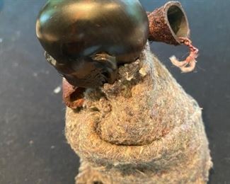 Lot 2171, $45.00. 5" African Ebony Wood carving of a man squatting wrapped in a blanket, holding an arrow quiver or drinking vessel. Signed, "MUZA" Kenya?