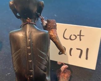 Lot 2171, $45.00. 5" African Ebony Wood carving of a man squatting wrapped in a blanket, holding an arrow quiver or drinking vessel. Signed, "MUZA" Kenya?