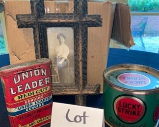 Lot 2172. $25.00. 2 antique or vintage tobacco tins & one old photo. Union Leader Redi-cut Tobacco; Lucky Strike cigarettes in tin & frame and an antique cabinet photo of a woman.