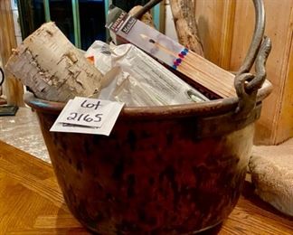 Lot 2165 $375.00 Large, antique hammered copper cauldron with forged iron handle, filled with logs and fireplace matches. 24"d x 12"h