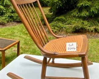 Lot 2206 $125.00 Vintage cane rocker with spindle back. 17" W x 30" D x 35" H