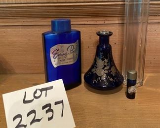 Lot 2237, $50.00 Vintage "Evening in Paris" Talcum Powder in a bottle; a small vial of "Evening in Paris" perfume; Beautiful Cobalt perfume bottle with gold floral etching; 7" tall clear Tulum bottle. Note: We later found a floral top that must have sat in the stopper of the cobalt bottle and did Gorilla Glue it to the top. Gorgeous, especially in front of a light source! See next photo. ALSO, the last lot of the sale (Lot 2553 is a vintage ad featuring these bottles! Perfect pair!)