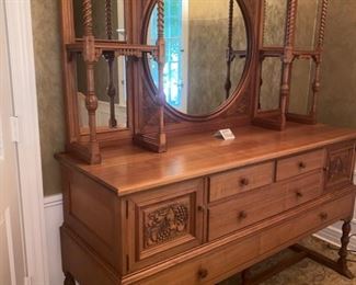 Lot 2265. $995.00. Unique Antique Buffet /Server and an open style mirror and shelving piece atop the buffet, with turned wood and interesting adornment. The two pieces coordinate, but are not an exact match, however, this was how the owners used these pieces. Selling as one lot. 4 drawers (2 w/liners for silverware) and 2 cubbies with beautiful carved front doors. "Buffet & Upper: Overall Height: 81""tall
Buffet: 66""w x 22""d x 37.25""
Upper: 43.5""h x 62""wx10.5""d. Mirror is 28.5 dia". Idea: The bottom half of this credenza could be used to hold a flat screen television, or of course as a buffet in a dining room, a foyer piece for storing gloves and hats or dog items, a bedroom as additional storage. Don't let the top piece (which is gorgeous) throw you off as to where you might use this! It's very functional in addition to beautiful.