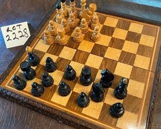 Lot 2228. $30.00. Wooden Chess Set (folds down the middle, beautifully carved edges with a hinge. Not all pieces included (14 tan and 15 black). We added an additional set of pieces, felt bottomed, plastic pieces.