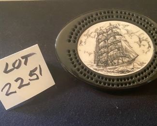 LOT 2251, $75.00. Old Clipper Ship Bone scrimshaw on a cribbage board. 6.75" x4.5" Be sure to specify if you are purchasing the scrimshaw, because apparently we assigned two lots to that number!!!! Sorry for the confusion.