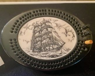 LOT 2251, $75.00. Old Clipper Ship Bone scrimshaw on a cribbage board. 6.75" x4.5" Be sure to specify if you are purchasing the scrimshaw, because apparently we assigned two lots to that number!!!! Sorry for the confusion.