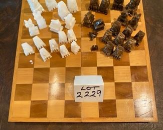 Lot 2229. $22.00. Onyx chess set. A few pieces have chips but could be fixed with strong glue. Wooden board needs a little love, some of this looks like it's been well loved!