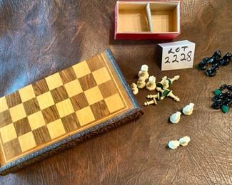 Lot 2228. $30.00. Wooden Chess Set (folds down the middle, beautifully carved edges with a hinge. Not all pieces included (14 tan and 15 black). We added an additional set of pieces, felt bottomed, plastic pieces, pictured here.