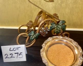 Lot 2275, $25.00. Reed and Barton Wine bottle coaster, 7.5" D, and a wine bottle caddy in a darling grapevine pattern