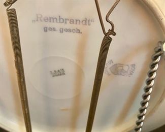 Lot 2283, $18.00. Pair of wooden candlesticks 12" tall, some wax residue. A Rembrandt Bavarian Plate. Take your pick; there are three names on the back of this plate!!, 11" diam, Scalloped edge with attached plate holder on the back of the plate. Easel not included..