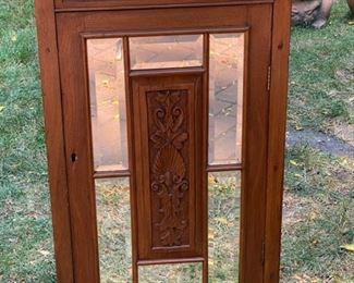 Lot 2304 $165.00 Mirrored, 4 shelf storage cabinet. Beveled mirrors on cabinet front with carved wood inlay. No key or knob 22" x 36.5"t x 16"d