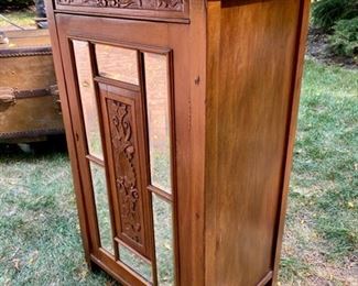 Lot 2304 $165.00 Mirrored, 4 shelf storage cabinet. Beveled mirrors on cabinet front with carved wood inlay. No key or knob 22" x 36.5"t x 16"d