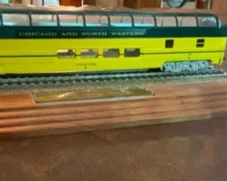 Lot 2261 $35.00 HO Chicago North Western (CNW) Passenger Car with Sky View Upper Deck mounted on Track and Wood Base with plaque.