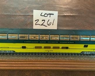 Lot 2261 $35.00 HO Chicago North Western (CNW) Passenger Car with Sky View Upper Deck mounted on Track and Wood Base with plaque.