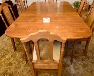 Lot 2266 $595.00. Beautiful Antique Dining Table with six Dining Chairs with Upholstered Seat Cushions (these were reupholstered by our homeowner). Dining Table has FOUR, COUNT THEM FOUR 12" Leaves and Custom Pads for the entire Table. This table will sit an army, perfect for upcoming Holidays! The Base is original and the 4 extra Legs were added for stability when the Leaves were being used (the FOUR support legs can be removed) the entire set has been restained and lightened to match the Buffet and Hutch in Lot 2293. Lot 2267 is a matching buffet in the original color. Table: 66" L x 46" W x 29" H. Each Leaf is 12" W x 46" L. There is also a small china cabinet in later lots that matches this set! At half price, of $297.50, this is truly a steal and in magnificent shape. You will hit yourself on the head if you don't buy this now!.