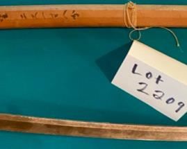 Lot 2209. $125.00 Very old Authentic Samurai Katana Sword. With leather-wrapped handle, Brass? inserts on the handle. Blade shows age. The wooden sheath is split has Japanese characters on it.