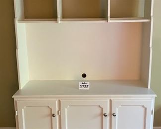Lot 2335. $195.00. One-piece media center w/shelves and 3 doors for great storage. This item is heavy and will need lots of muscle for you to move it... We will NOT be moving this for you:). This could double as a kitchen hutch, storing dishware, table cloths or place mats, larger display pieces on the shelves. Or holding a tv in the bedroom or guest room, or even an office. Soft white/cream finish; this was made with care, 52"w x 19"d x 79" t