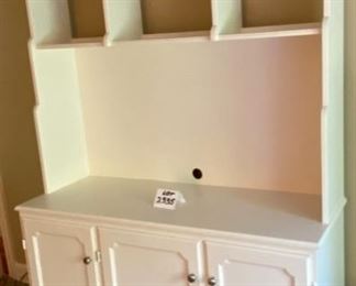 Lot 2335. $195.00. One-piece media center w/shelves and 3 doors for great storage. This item is heavy and will need lots of muscle for you to move it... We will NOT be moving this for you:). This could double as a kitchen hutch, storing dishware, table cloths or place mats, larger display pieces on the shelves. Or holding a tv in the bedroom or guest room, or even an office. Soft white/cream finish; this was made with care, 52"w x 19"d x 79" t
