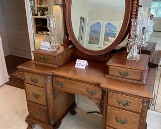 Lot 2341 $250.00 Nice Old Antique Vanity w/ 2 Bible Boxes" 6 side drawers and one center drawer and oval mirror with barley twist supports. Has cute little feet! 48" W x 19.5" D x 65" H. Matching Bench Not Pictured here. This would be darling as it is now, or painted, for a little girl's or teen's room, a guest room or removing the mirror piece and using as a desk. At half price, it's a steal.