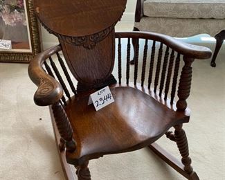 Lot 2344. $200.00. Oh, what a wonderful Antique Rocking Chair. Look at the woodwork, the turned legs, and supports under the curved arms! The head support and all the turned spindles. This is truly a piece of art! Now then, we have Lot # 2344. Victorian Quarter Sawn Oak Rocking Chair. Gorgeous - missing a small piece of veneer on top left. Even modern homes need to have a nice antique piece to give the home character. Buy this now, before you change your mind!