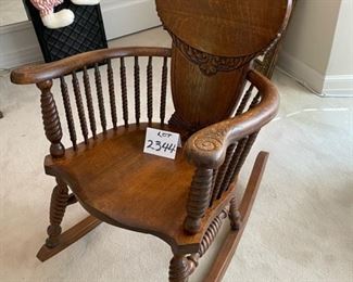 Lot 2344. $200.00. Oh, what a wonderful Antique Rocking Chair. Look at the woodwork, the turned legs, and supports under the curved arms! The head support and all the turned spindles. This is truly a piece of art! Now then, we have Lot # 2344. Victorian Quarter Sawn Oak Rocking Chair. Gorgeous - missing a small piece of veneer on top left. Even modern homes need to have a nice antique piece to give the home character. Buy this now, before you change your mind!