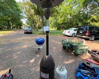 Lot 2314 $125.00 AZ Patio Propane gas heater. 41,000 BTU includes 1 FULL propane tank. The top Cover of the Heater is slightly bent, as shown in the photo. We think it looks like a guy tipping his cowboy hat, and we like it!