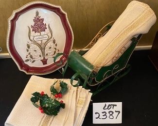 Lot 2387. $24.00 All the Trimmings Platter (Grasslands Rd. Large Platter) Green Sleigh. 4 Dept. 56 metal napkin rings. 10 Ivory and Gold Placemats and 12 napkins (have small stains but freshly dry cleaned)