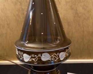 Lot 2391 $48.00. Vintage Amber/Brown Glass lamp w/ Hand-painted leaf vine motif and dots. Tested. The lamp is a little crooked at the base. Not sure if this can be fixed. With the right shade, you wouldn't notice it! Metal base 33" to top of harp, 19" to top of the glass.