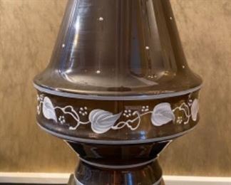Lot 2391 $48.00. Vintage Amber/Brown Glass lamp w/ Hand-painted leaf vine motif and dots. Tested. The lamp is a little crooked at the base. Not sure if this can be fixed. With the right shade, you wouldn't notice it! Metal base 33" to top of harp, 19" to top of the glass.