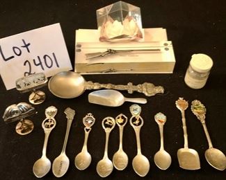 Lot 2401. 9 souvenir spoons, 1 pewter scooper, 1 small W. Germany scooper, Mt. St. Helens Ash, Sharps Creedmore in lucite and flower in lucite. Plus 2 antique sterling place card holders.