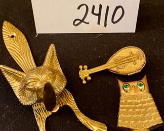 Lot 2410. $65.00 8 pc Lot featuring: Fox Door Knocker (brass), Antique mini nude (painted on the ceramic), Nippon china footed trinket dish and small bowl, cool marble egg, and ceramic baby shoe, Brass Owl Pin, and Brass Lute Pill Hinged Box.