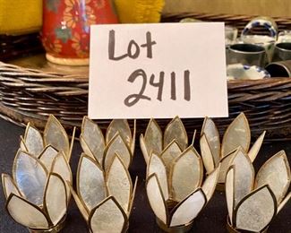 Lot 2411. $55.00. Vintage Wicker Tray with embroidery under glass (Some damage on one handle, 20"x13"), Mustard Napkins w/holder, 8 vintage place card holders (vintage flowers w/glass inserts), 12 napkin rings (signed mexican ceramics), 3 pewter or bronze napkin rings.