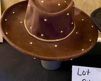 Lot 2415. $45.00. 2 ladies wool hats. 1) 100% wool felt hat, brown with gold-toned metal dots and herringbone chain. 2) 100% wool felt hat, black with brass tone ring around the hat.