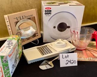 Lot 2420. $54.00. 2 measuring cups, taste of home glass trivet, cheese slicer, Vintage (like new), Moulinex multi-grater, New Ulu Factory chopper blade, block and bowl, OXO Good Grips Salad Spinner (in box), 4 papered chef food chopper with multiple attachments.