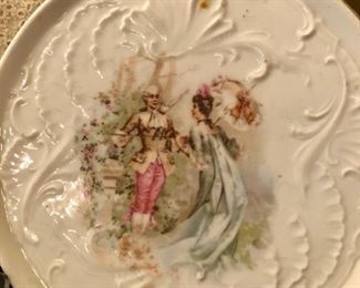 Lot 2431. $28.00 9 pc lot: Vintage Framed Doily, Ceramic Trivet, hand-painted Nippon trinket dish with fork, 3 mini Christmas bells, 2 small ceramic animals, 1 silver tone wire basket