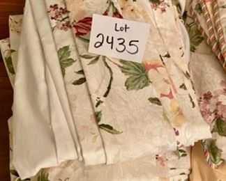 Lot 2435. $175.00. Such a good deal! Large Custom Bedding Set (with window treatments). 4 roman shades or panels (can't tell on 2 of them), window valance, 2 plaid pillows with pompoms, 1 throw pillow, 1 full duvet with insert (reverse to butter yellow), 1 full bedskirt, 2 custom pillows.
