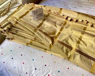Lot 2442. $450.00. Custom-made and absolutely gorgeous silk fine drapery, 4 panels. Gold plaid with tassels and adornments. 87" L x 26" gathered at the top. These draperies can be reworked, but the silk fabric is exquisite.