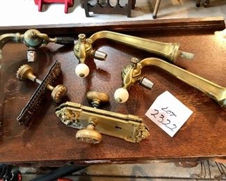 Lot 2322. $250.00. Antique Brass Door Knob and plate, a lighter metal doorknob (still old) and plate, 3 bar draft pulls or faucets? 2 have white pulls one has a black pull.
