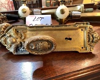 Lot 2322. $250.00. Antique Brass Door Knob and plate, a lighter metal doorknob (still old) and plate, 3 bar draft pulls or faucets? 2 have white pulls one has a black pull.