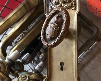 Lot 2322. $250.00. Antique Brass Door Knob and plate, a lighter metal doorknob (still old) and plate, 3 bar draft pulls or faucets? 2 have white pulls one has a black pull.