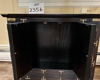 Lot 2356. $175.00. Small 2 door Asian inspired side table/cabinet. Black and Brass. Very very solidly made and heavy! The interior is open, no shelves, great extra storage. Cool brass details. 26"w x 16" d x 22" tall d x 22" tall