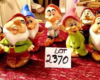Lot 2370. $50.00. Set of Snow White's 7 dwarfs Ceramics. Bashful has a chip on the blue hat rim. Doc has a chip on nose.