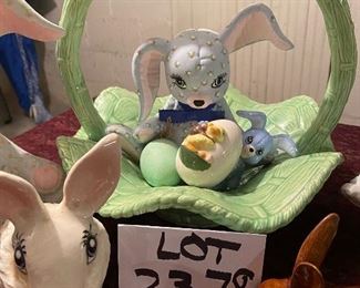Lot 2378, $50.00. Big lot of Easter: cabbage basket w/ bunny; Brown Bunny; White cotton ball holder bunny; Bunny bank 9" tall; small bunny bank; tiny bunny