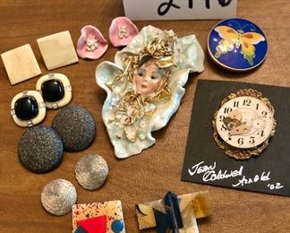 Lot 2446. $48.00. 2 glass paperweights (in next picture) and Jewelry Lot: 4 pins/brooches- "House Pins by Lucinda (ME), Japanese Coat w/hummingbird, Jean Coldwell Arnold watch face, "Wearable Art by Rosemary from Pana, IL". 1 cloisonne belt buckle/tie gatherer, 3 clip earrings, 2 pierced.