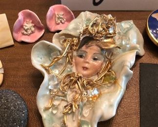 Lot 2446. $48.00. 2 glass paperweights and Jewelry Lot: 4 pins/broaches- "House Pins by Lucinda (ME), Japanese Coat w/hummingbird, Jean Coldwell Arnold watch face, "Wearable Art by Rosemary from Pana, IL". 1 cloisonne belt buckle/tie gatherer, 3 clip earrings, 2 pierced.