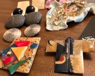 Lot 2446. $48.00. 2 glass paperweights and Jewelry Lot: 4 pins/broaches- "House Pins by Lucinda (ME), Japanese Coat w/hummingbird, Jean Coldwell Arnold watch face, "Wearable Art by Rosemary from Pana, IL". 1 cloisonne belt buckle/tie gatherer, 3 clip earrings, 2 pierced.